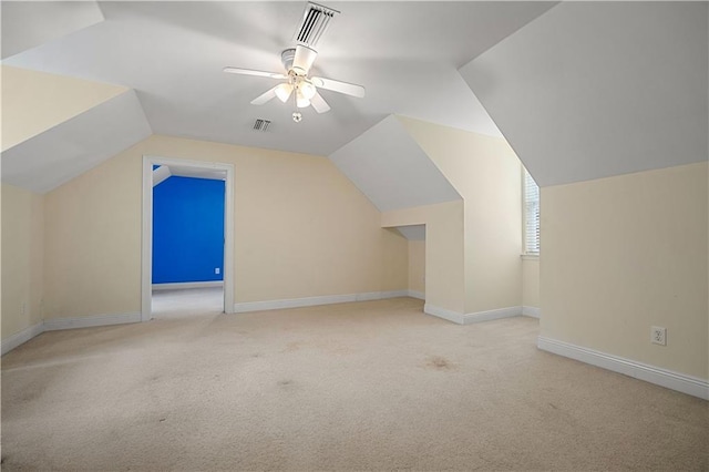 additional living space featuring ceiling fan, light carpet, and vaulted ceiling