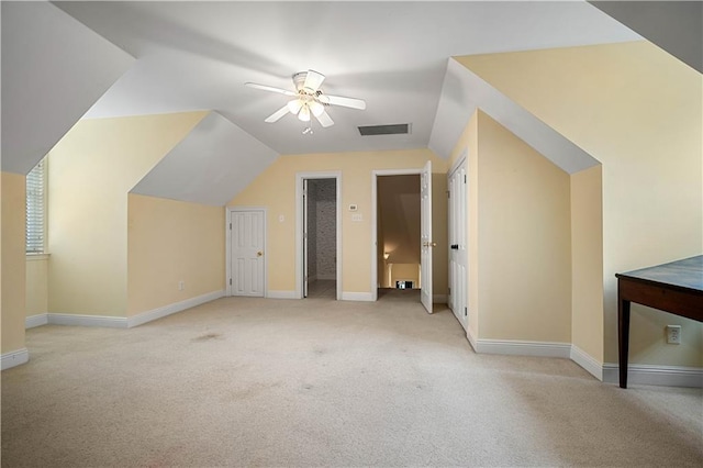 additional living space featuring ceiling fan, lofted ceiling, and light carpet