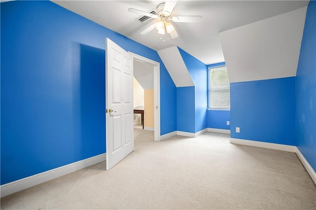 additional living space with ceiling fan, light colored carpet, and lofted ceiling