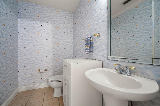 bathroom featuring tile patterned floors, toilet, and sink