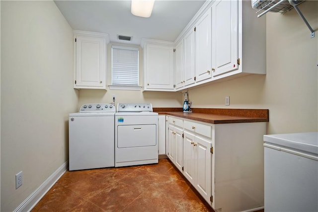 laundry room featuring cabinets, tile patterned flooring, and washer and dryer