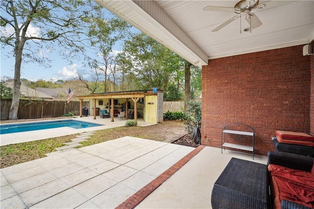 view of patio with a fenced in pool and ceiling fan