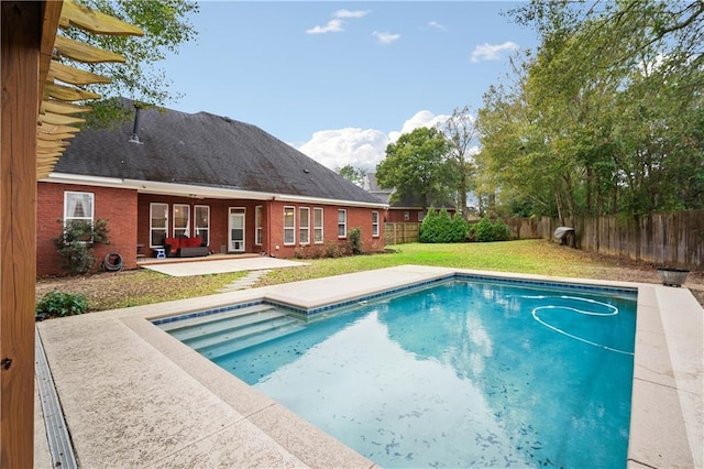 view of pool featuring a lawn and a patio area