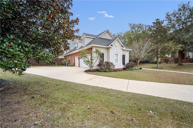 view of front of home with a front yard and a garage