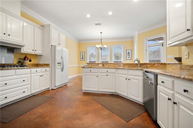 kitchen featuring sink, appliances with stainless steel finishes, a notable chandelier, white cabinetry, and extractor fan