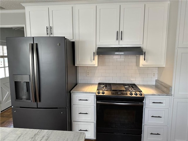 kitchen with crown molding, stainless steel fridge, white cabinetry, tasteful backsplash, and gas range oven