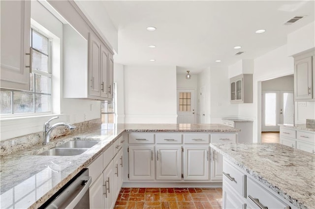 kitchen featuring sink, white cabinets, dishwasher, and light stone counters