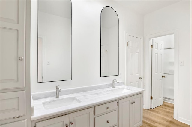 bathroom with vanity and hardwood / wood-style floors