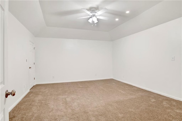 carpeted spare room featuring ceiling fan and vaulted ceiling