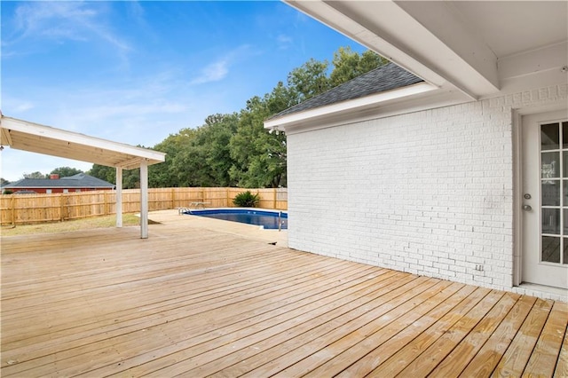 wooden deck featuring a fenced in pool