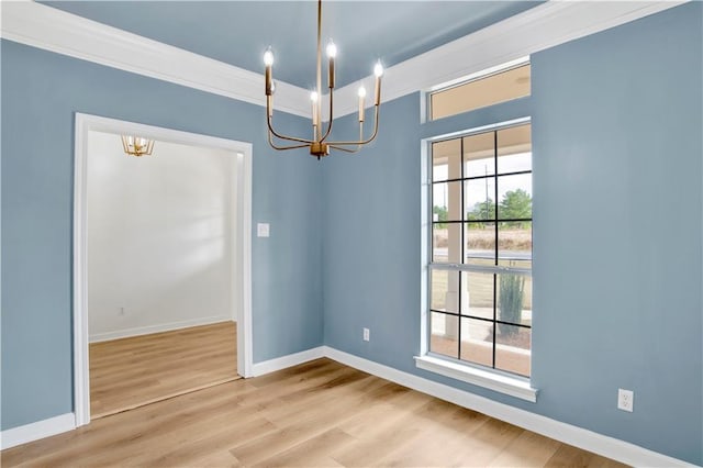 unfurnished dining area with hardwood / wood-style floors, crown molding, and a notable chandelier