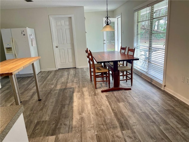 dining space with dark hardwood / wood-style flooring