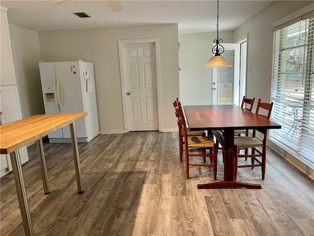 dining area with dark hardwood / wood-style flooring, ceiling fan, and a wealth of natural light