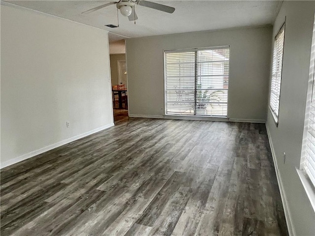 unfurnished room featuring dark hardwood / wood-style flooring, ceiling fan, and plenty of natural light