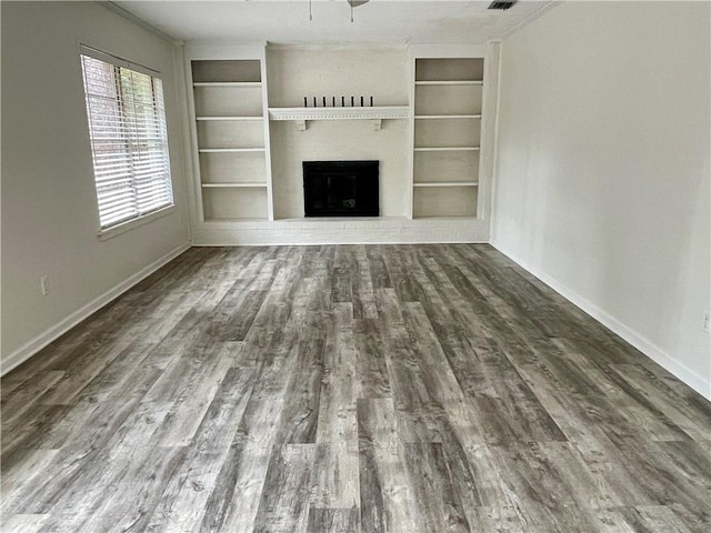 unfurnished living room featuring built in features and wood-type flooring