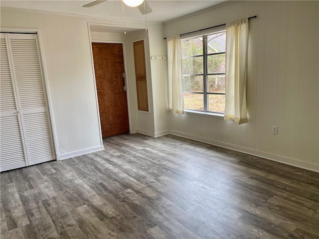 unfurnished bedroom with ceiling fan, multiple windows, and hardwood / wood-style flooring