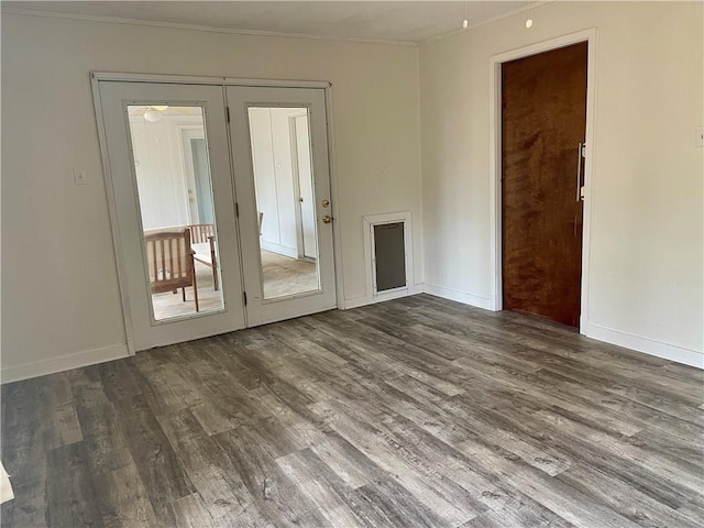 empty room with dark hardwood / wood-style floors and french doors