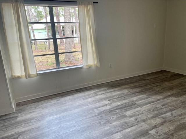 unfurnished room featuring plenty of natural light and hardwood / wood-style flooring