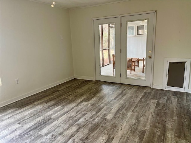 spare room with dark hardwood / wood-style flooring, ornamental molding, and french doors