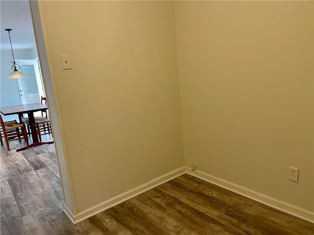 empty room with dark hardwood / wood-style flooring