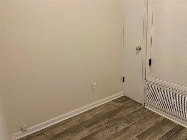 laundry area with wood-type flooring