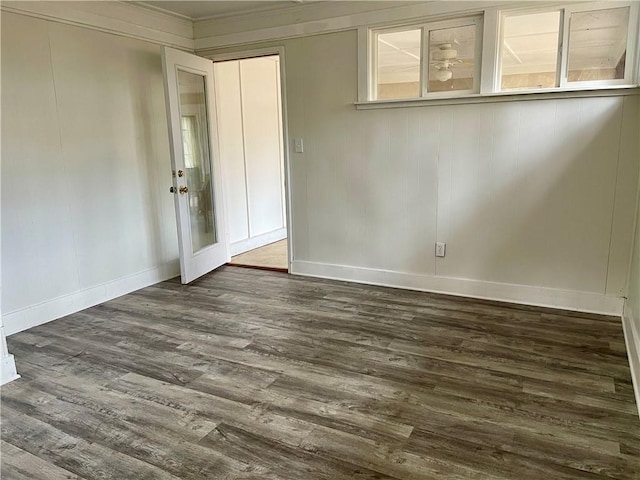 unfurnished room featuring dark hardwood / wood-style floors and crown molding