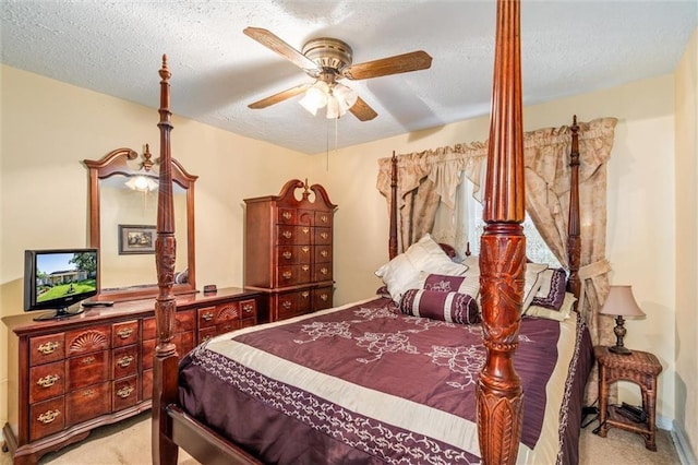 bedroom featuring carpet floors, a textured ceiling, and a ceiling fan