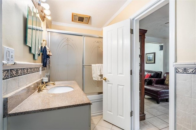 ensuite bathroom with vanity, ornamental molding, tile patterned floors, ensuite bath, and enclosed tub / shower combo