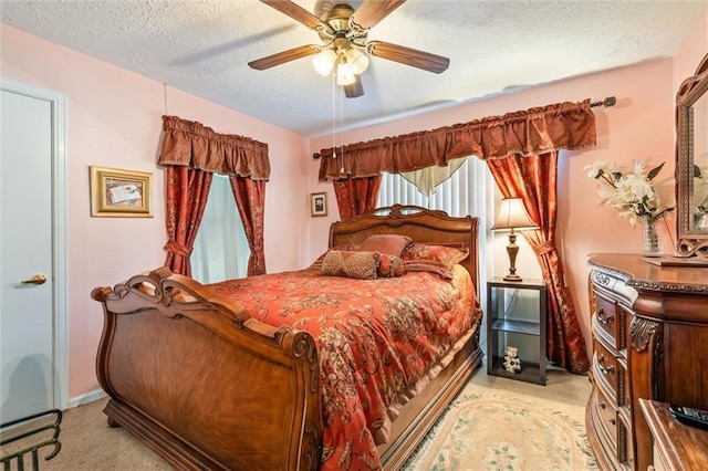 bedroom with light carpet, a textured ceiling, and a ceiling fan