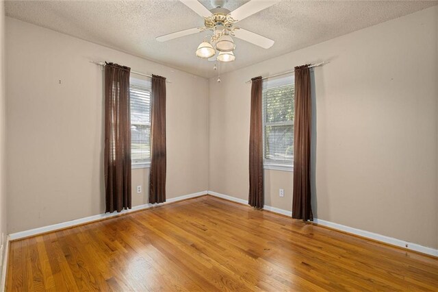 1113 4th Ave, Saraland, AL 36571 - spare room with wood finished floors, a textured ceiling, and ceiling fan