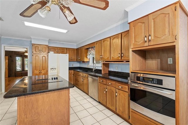 1113 4th Ave, Saraland, AL 36571 - kitchen with stainless steel appliances, ceiling fan, light tile patterned floors, a kitchen island, and crown molding