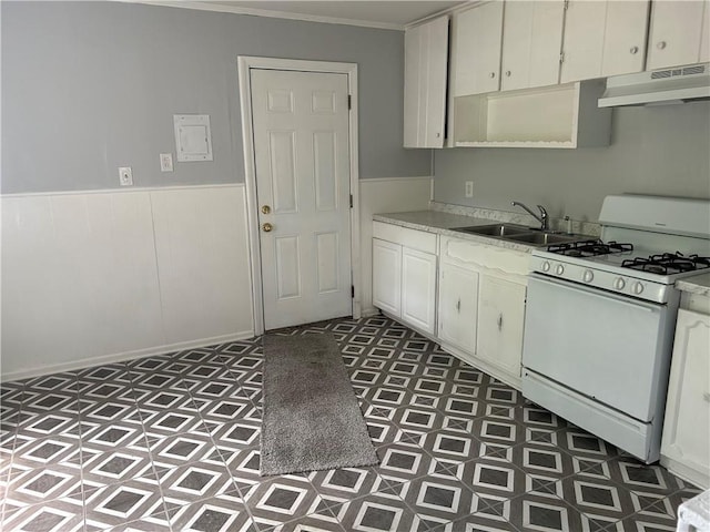 3052 Jane St, Mobile, AL 36606 - kitchen with a sink, white gas range, tile patterned floors, under cabinet range hood, and light countertops