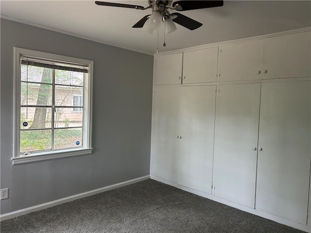 3052 Jane St, Mobile, AL 36606 - unfurnished bedroom featuring dark carpet, multiple windows, ornamental molding, and a ceiling fan