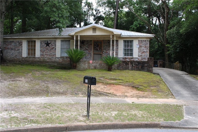 2517 Pinecliff Ct N, Mobile, AL 36605 - ranch-style house featuring metal roof, concrete driveway, covered porch, and brick siding