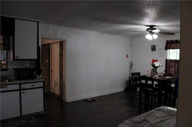 2517 Pinecliff Ct N, Mobile, AL 36605 - dining area with ceiling fan, dark wood finished floors, a textured ceiling, and baseboards