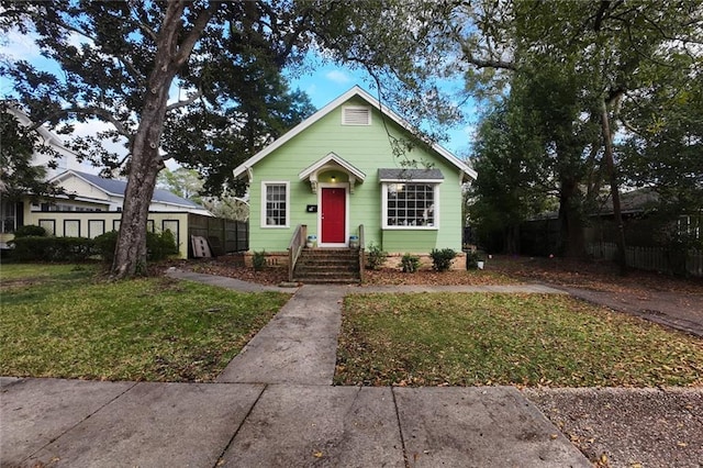 bungalow-style house featuring a front yard