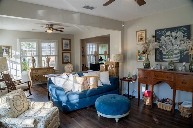 living room featuring ceiling fan and dark hardwood / wood-style floors