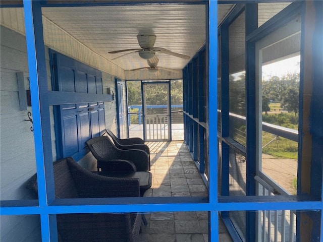 sunroom / solarium with a healthy amount of sunlight and ceiling fan