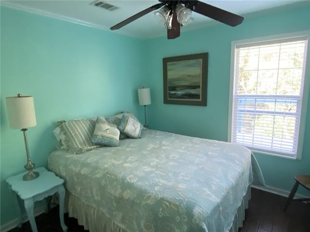 bedroom with ceiling fan and dark hardwood / wood-style flooring