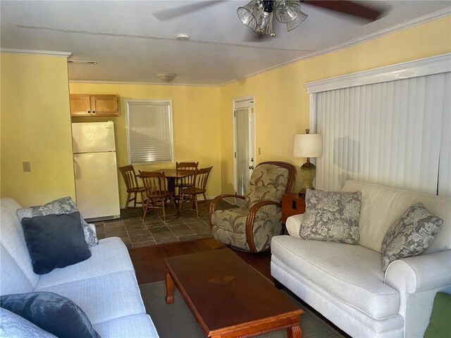 living room with crown molding, ceiling fan, and dark hardwood / wood-style floors