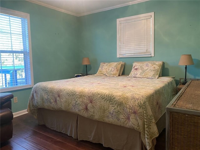 bedroom with ornamental molding and dark wood-type flooring