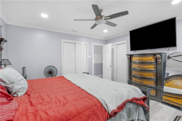 bedroom with visible vents, a ceiling fan, ornamental molding, two closets, and recessed lighting