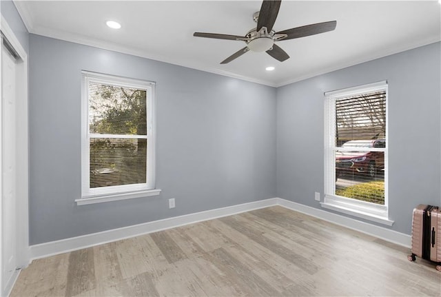 empty room with ornamental molding, plenty of natural light, and baseboards