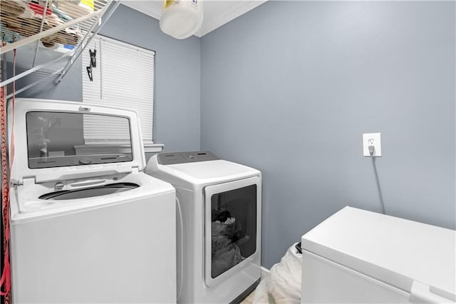 clothes washing area featuring washer and dryer and laundry area