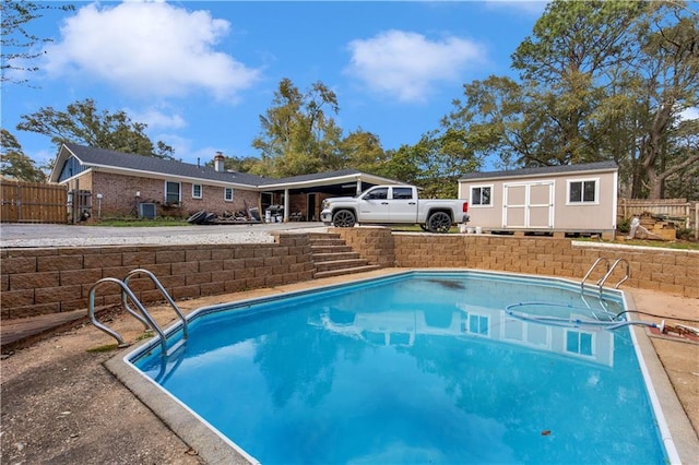 view of pool featuring an outbuilding, fence, and a fenced in pool