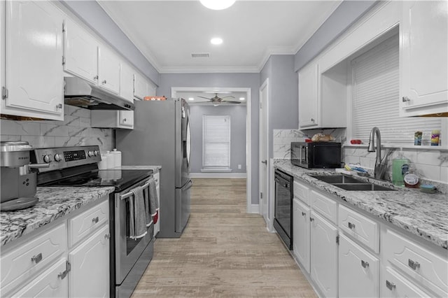 kitchen with crown molding, white cabinetry, a sink, under cabinet range hood, and black appliances