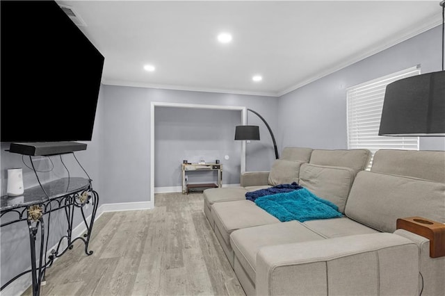 living room with ornamental molding, light wood-type flooring, recessed lighting, and baseboards