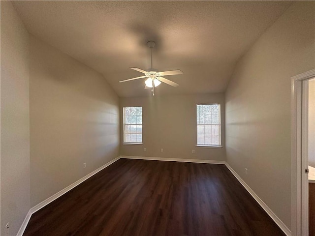 unfurnished room with ceiling fan, lofted ceiling, plenty of natural light, and dark hardwood / wood-style flooring