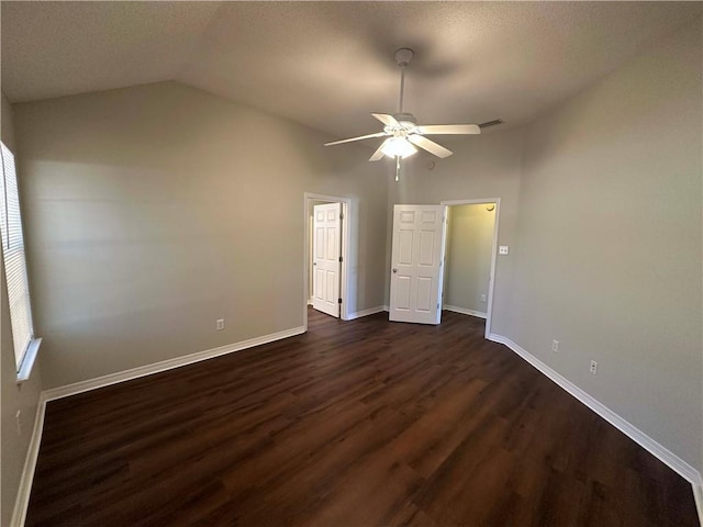 unfurnished bedroom with ceiling fan, lofted ceiling, and dark hardwood / wood-style flooring