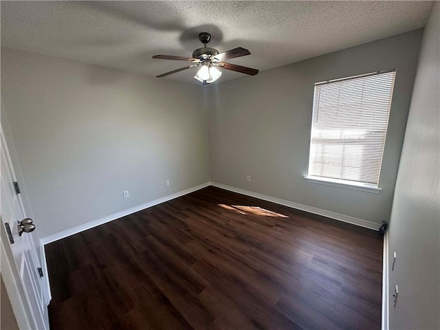 empty room featuring dark hardwood / wood-style flooring, a textured ceiling, and ceiling fan